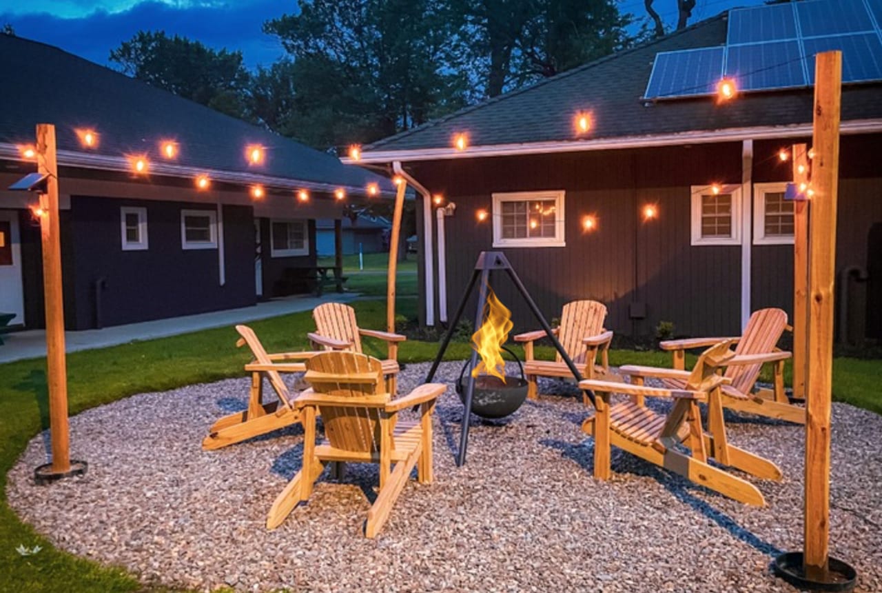 Lakeside fire pit and Adirondack chairs at dusk